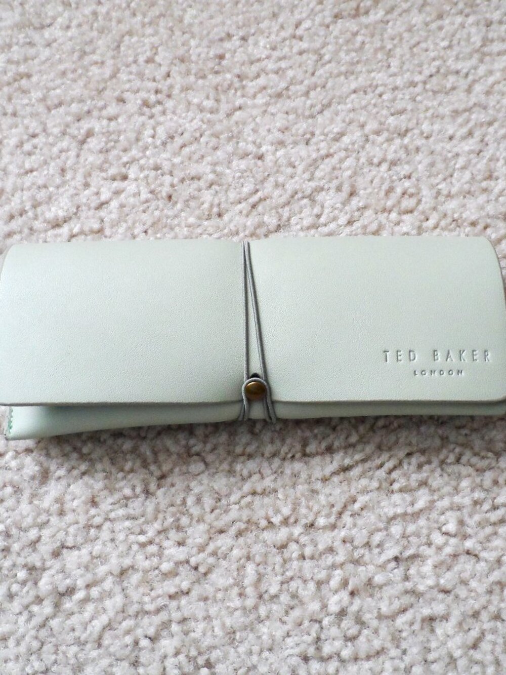 Ted Baker London soft glasses case  in a mint green color  with wrap closure